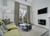 Thumbnail 56 of 80 - a living room with a couch and a coffee table and a fireplace