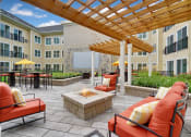 Thumbnail 28 of 80 - an outdoor patio with couches and chairs and a fire pit