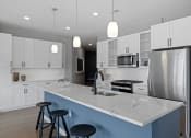 Thumbnail 42 of 61 - a kitchen with white cabinets and a large island with three stools