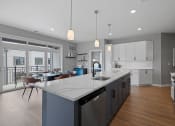 Thumbnail 43 of 61 - an open kitchen and dining room with a large marble counter top