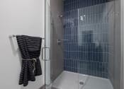 Thumbnail 52 of 61 - a shower with a glass door in a bathroom
