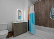 Thumbnail 53 of 61 - a bathroom with a toilet sink and tub and a shower