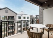 Thumbnail 55 of 61 - a patio with a table and chairs on a balcony