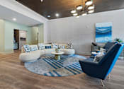 Thumbnail 3 of 70 - Resident lounge with curved sofa and modern furnishings at Aster Grove Apartments, New Jersey