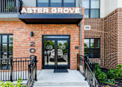 Thumbnail 70 of 70 - Building entrance with black framed glass doors at Aster Grove Apartments, New Jersey, 07059