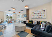 Thumbnail 27 of 70 - Colorful childrens playroom with toys and seating at Aster Grove Apartments, Warren, NJ 07059