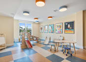 Thumbnail 28 of 70 - Childrens playroom with colorful ceiling lights at Aster Grove Apartments, Warren, NJ
