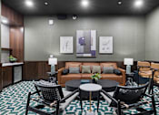 Thumbnail 30 of 70 - Resident lounge with leather sofa and modern furnishings at Aster Grove Apartments, Warren, 07059
