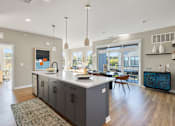Thumbnail 44 of 61 - A modern kitchen with a large island and a view of the backyard.