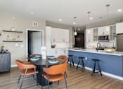Thumbnail 40 of 61 - A modern kitchen with a dining table and chairs.