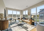 Thumbnail 46 of 61 - A living room with a large window and a view of the outside.