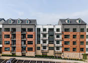 Thumbnail 61 of 61 - Two apartment buildings with balconies and windows.