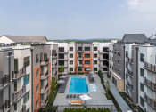 Thumbnail 29 of 61 - an aerial view of an apartment building with a pool