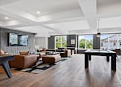 Thumbnail 23 of 61 - A modern living room with brown leather furniture and a flat screen TV mounted on the wall.