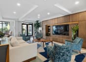 Thumbnail 14 of 61 - a living room with couches and chairs and a television