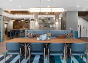 Thumbnail 7 of 61 - a dining room with blue chairs and a wooden table