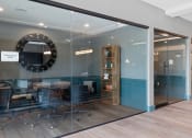 Thumbnail 11 of 61 - a conference room with glass walls and a mirror