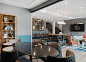 Thumbnail 12 of 61 - A modern dining area with a large table and chairs.