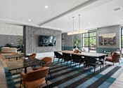 Thumbnail 6 of 61 - A modern dining room with a long table and chairs.