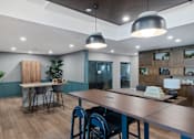 Thumbnail 10 of 61 - A modern dining room with a wooden table and chairs.