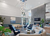 Thumbnail 2 of 61 - A modern living room with a fireplace and a large painting on the wall.