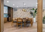 Thumbnail 17 of 61 - a dining room with a wooden table and chairs