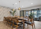 Thumbnail 18 of 61 - a dining room with a wooden table and chairs