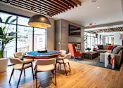 Thumbnail 6 of 53 - Game table lounge with pendant lighting and seating at Inwood at Renaissance Square Apartments, Marlton