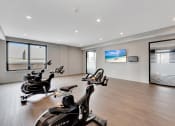 Thumbnail 10 of 35 - a gym with treadmills and a tv on the wall
