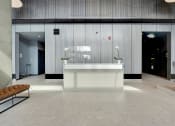 Thumbnail 1 of 35 - a large lobby with a reception desk and white flowers