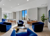 Thumbnail 11 of 35 - a living room with blue chairs and a table