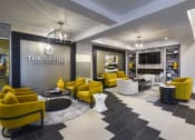 Thumbnail 3 of 80 - a lobby with yellow couches and chairs and a sign that reads the grange