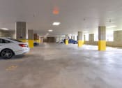Thumbnail 27 of 80 - a parking garage with cars in it and an exit sign