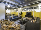 Thumbnail 11 of 80 - a living room with couches and chairs and a television