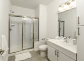 Thumbnail 58 of 80 - a white bathroom with a shower toilet and sink