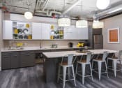 Thumbnail 5 of 80 - a kitchen with a long island with chairs and a table