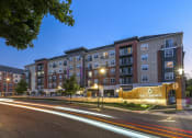 Thumbnail 80 of 80 - a city street with an apartment building at night
