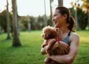Thumbnail 77 of 80 - a woman holding a teddy bear in a park