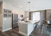 Thumbnail 34 of 53 - Modern kitchen with island and pendant lighting at Inwood at Renaissance Square Apartments, Marlton