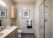 Thumbnail 41 of 53 - Bathroom with wood vanity and walk-in shower at Inwood at Renaissance Square Apartments, Marlton, NJ