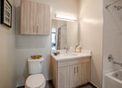 Thumbnail 40 of 53 - Bathroom with wood tone vanity and mirror cabinet at Inwood at Renaissance Square Apartments, Marlton, 08053