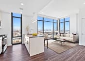 Thumbnail 20 of 35 - an open living room with a kitchen and a view of the city