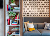 Thumbnail 4 of 53 - Builtin bookshelf with gray sofa and decorative pillows at Inwood at Renaissance Square Apartments, Marlton, NJ