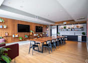 Thumbnail 12 of 53 - Communal dining space with long wood table and pegboard wall at Inwood at Renaissance Square Apartments, Marlton, NJ