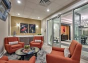 Thumbnail 26 of 80 - a living room with orange chairs and a table
