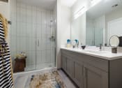 Thumbnail 39 of 44 - Bathrooms with Gray Shaker Vanities & Full Height Tiled Wet Walls