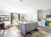 Thumbnail 30 of 44 - a kitchen and living room with white walls and hardwood floors