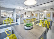Thumbnail 14 of 80 - a dining room with yellow chairs and a table with a plant on it