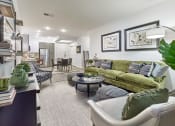 Thumbnail 54 of 80 - a living room with a green couch and a table