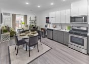 Thumbnail 60 of 80 - a kitchen and living room with stainless steel appliances and a table